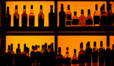 backlit bottles on shelf of bar