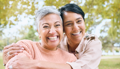 elderly couple smiling at the camera