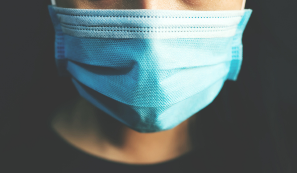 close up of person wearing face mask to protect against COVID