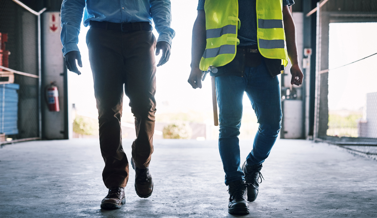 Shot of two unrecognisable builders walking through a construction site