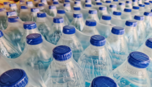 Large number of packed bottled drinking water with blue caps
