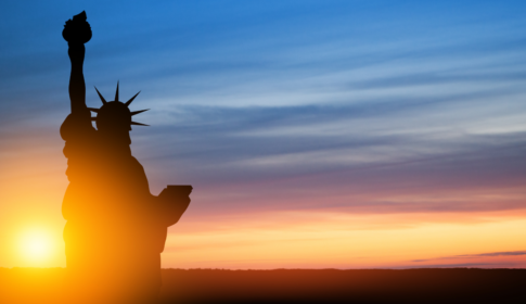 Statue of Liberty on background of sunset sky